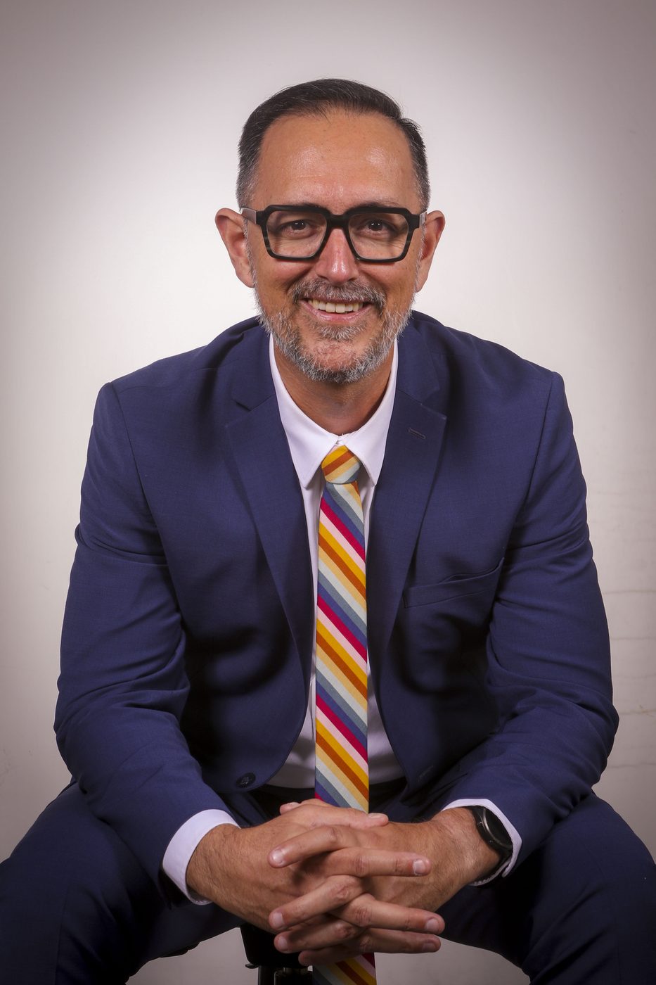 Jeremy Higgins, broker associate at Compass, in a navy suit and striped tie
